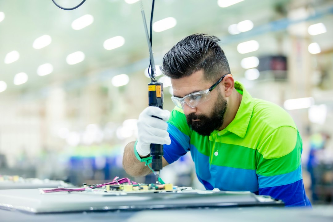 Technician working with industrial equipment in a factory